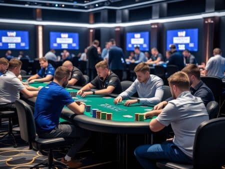 A group of men play poker around a green table in a modern, well-lit casino. Other players and tables are visible, with large screens displaying WSOP events and tournament information in the background.