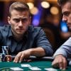Two men sit at a poker table with chips and cards in front of them, both focused and serious as they play in a dimly lit casino setting, each intent on spotting deception and recognizing any subtle poker tells from their opponent.