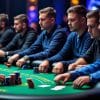 Several men sit around a green poker table in a casino, using Final Table Tactics as they focus on the game. Stacks of poker chips and dramatic lighting create an intense atmosphere, highlighting their mastery of MTT Poker Strategy.