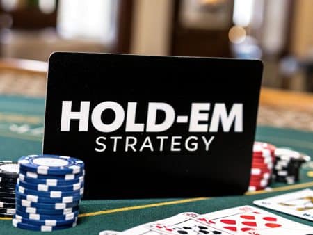 A sign reading HOLD-EM STRATEGY stands on a poker table with stacks of poker chips, playing cards, and part of a green felt table visible in the background.